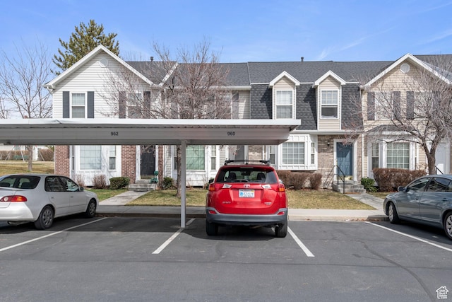 962 N Independence W, Provo, UT 84604 - view of front of home with a shingled roof, covered and uncovered parking, and brick siding