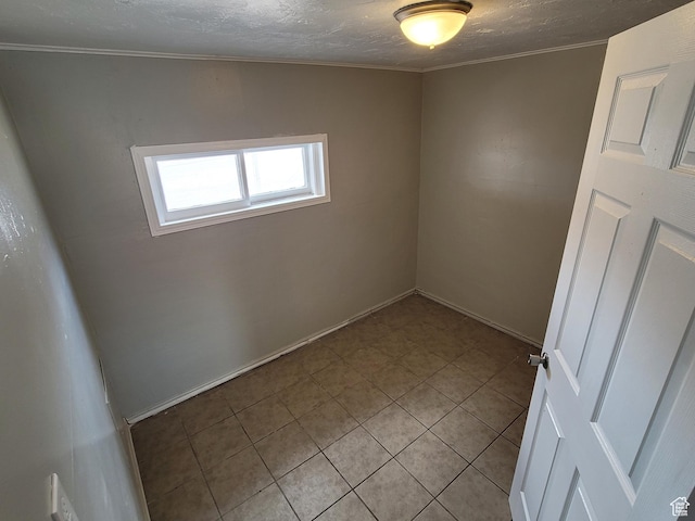 250 8th St, Wendover, UT 84083 - spare room featuring light tile patterned floors, a textured ceiling, and crown molding