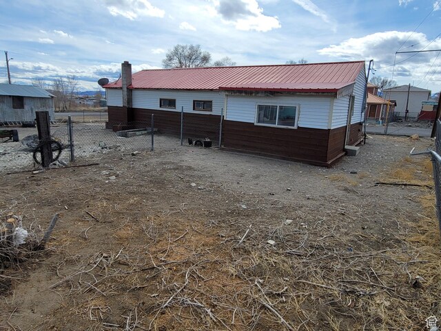 250 8th St, Wendover, UT 84083 - rear view of house featuring metal roof and fence