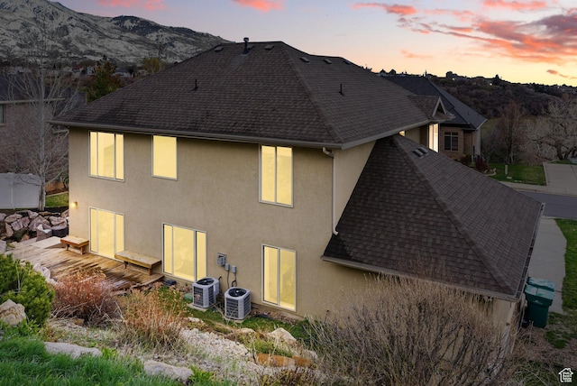 1637 E 2400 N, Layton, UT 84040 - rear view of house featuring a shingled roof, a mountain view, stucco siding, and central AC