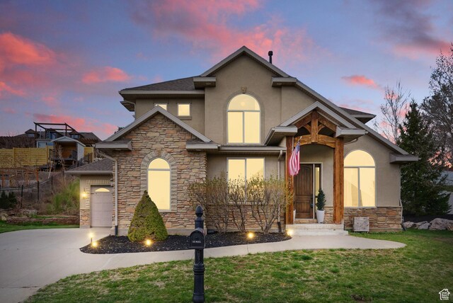 1637 E 2400 N, Layton, UT 84040 - traditional-style home with stucco siding, an attached garage, stone siding, driveway, and a lawn