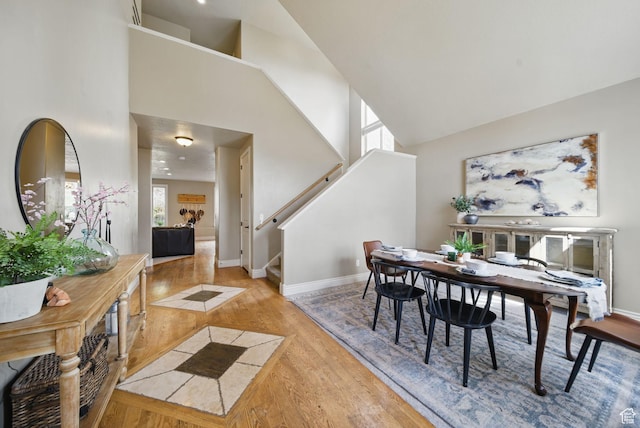1637 E 2400 N, Layton, UT 84040 - dining space featuring baseboards, high vaulted ceiling, stairway, and light wood-type flooring