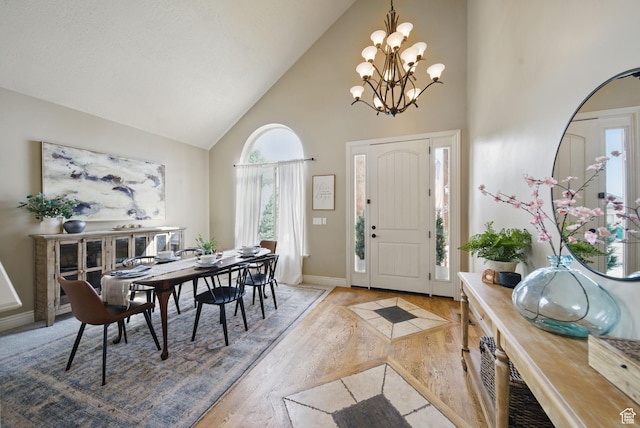 1637 E 2400 N, Layton, UT 84040 - entryway featuring baseboards, a notable chandelier, high vaulted ceiling, and wood finished floors