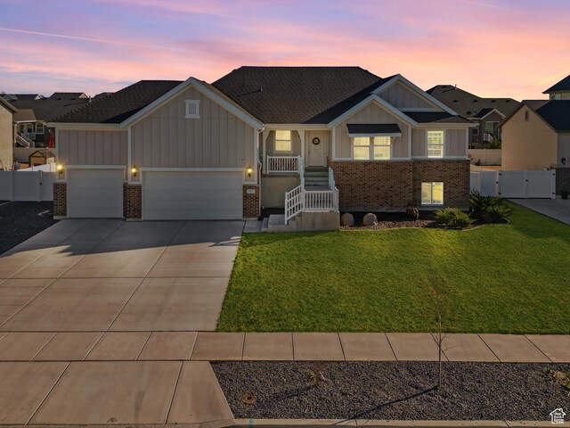 3457 W Blue Crane Dr N, Clinton, UT 84015 - view of front of property with board and batten siding, brick siding, and a gate