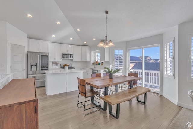 3457 W Blue Crane Dr N, Clinton, UT 84015 - dining area featuring a chandelier, light wood-type flooring, lofted ceiling, recessed lighting, and baseboards