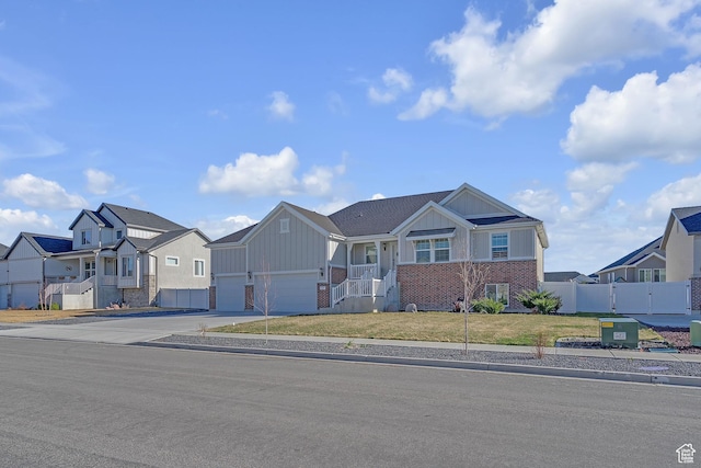 3457 W Blue Crane Dr N, Clinton, UT 84015 - view of front of home with board and batten siding, brick siding, concrete driveway, a residential view, and an attached garage