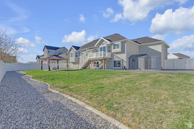 3457 W Blue Crane Dr N, Clinton, UT 84015 - back of property featuring a gazebo, a storage shed, stairs, an outdoor structure, and stucco siding