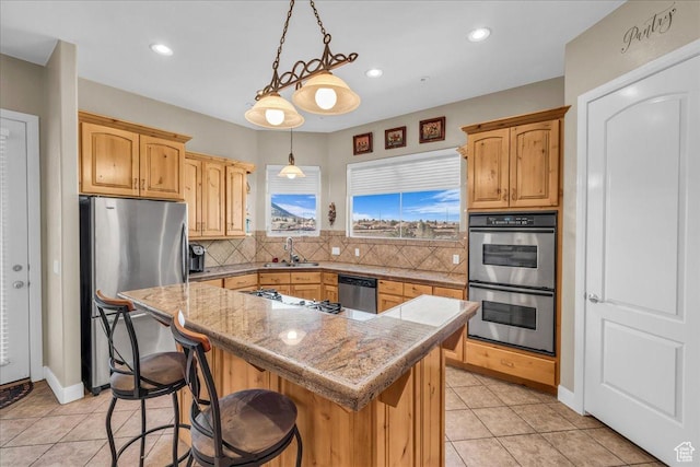 799 N 2600 W, Hurricane, UT 84737 - kitchen featuring tasteful backsplash, light tile patterned floors, stainless steel appliances, a kitchen island, and a sink