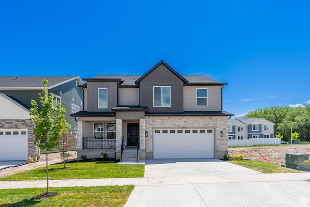 3901 W 950 N Unit 365, Lehi, UT 84043 - view of front of property with driveway, a garage, stone siding, board and batten siding, and a front lawn