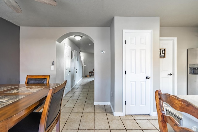 1301 W Indian Hills Dr Unit 59, St George, UT 84770 - dining area featuring light tile patterned flooring, baseboards, arched walkways, and ceiling fan