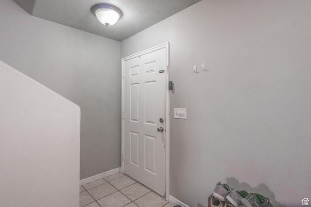 1301 W Indian Hills Dr Unit 59, St George, UT 84770 - doorway featuring light tile patterned flooring, baseboards, and a textured ceiling