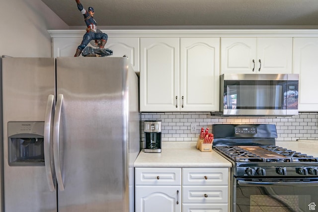 1301 W Indian Hills Dr Unit 59, St George, UT 84770 - kitchen featuring white cabinets, light countertops, backsplash, and stainless steel appliances