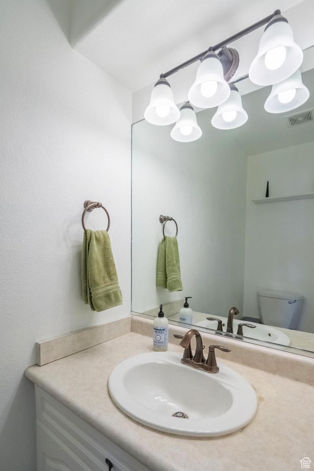 1301 W Indian Hills Dr Unit 59, St George, UT 84770 - half bathroom with visible vents, toilet, and vanity