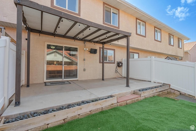 1301 W Indian Hills Dr Unit 59, St George, UT 84770 - rear view of house featuring stucco siding, fence, a lawn, and a patio