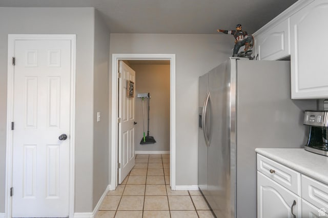 1301 W Indian Hills Dr Unit 59, St George, UT 84770 - kitchen featuring light tile patterned flooring, light countertops, stainless steel refrigerator with ice dispenser, baseboards, and white cabinets