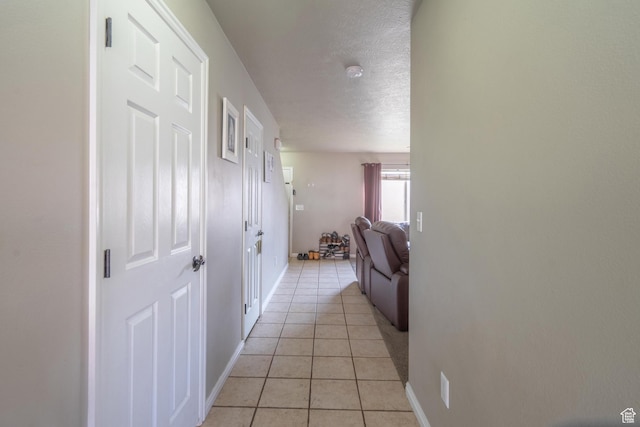 1301 W Indian Hills Dr Unit 59, St George, UT 84770 - corridor featuring light tile patterned flooring, a textured ceiling, and baseboards