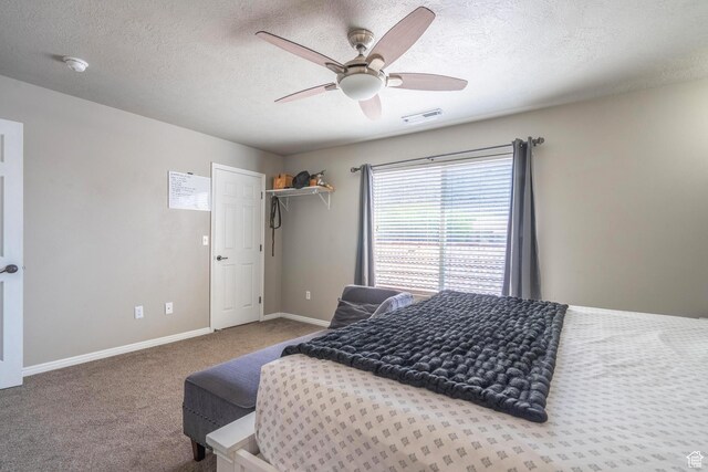 1301 W Indian Hills Dr Unit 59, St George, UT 84770 - bedroom with carpet flooring, a textured ceiling, visible vents, baseboards, and a ceiling fan