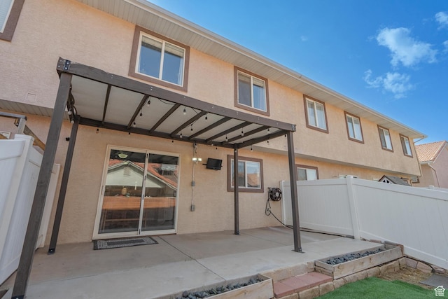 1301 W Indian Hills Dr Unit 59, St George, UT 84770 - rear view of property with stucco siding, fence, and a patio