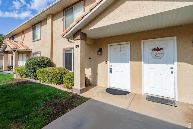 1301 W Indian Hills Dr Unit 59, St George, UT 84770 - view of exterior entry featuring stucco siding