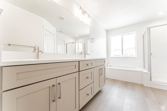 3877 W 950 N Unit 367, Lehi, UT 84043 - bathroom with a shower stall, double vanity, wood finished floors, a bath, and recessed lighting
