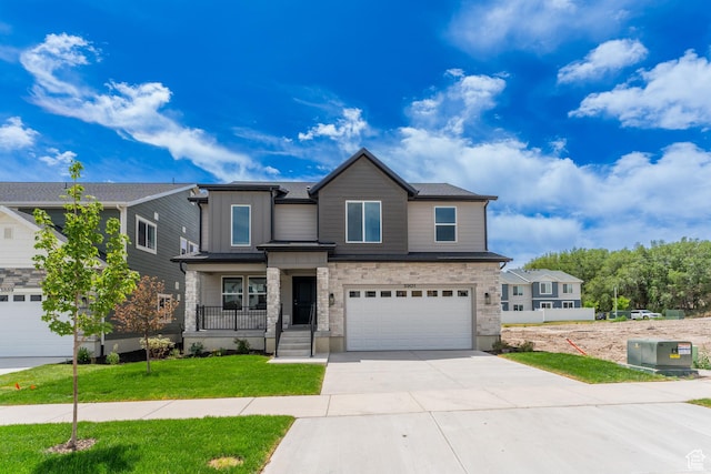 3877 W 950 N Unit 367, Lehi, UT 84043 - view of front of property featuring driveway, a garage, a front lawn, stone siding, and board and batten siding