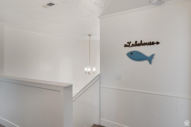199 N 300 W, Garden City, UT 84028 - corridor featuring an upstairs landing, a textured ceiling, wainscoting, visible vents, and an inviting chandelier