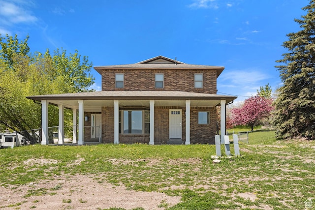 199 N 300 W, Garden City, UT 84028 - view of front of home with covered porch, brick siding, and a front yard
