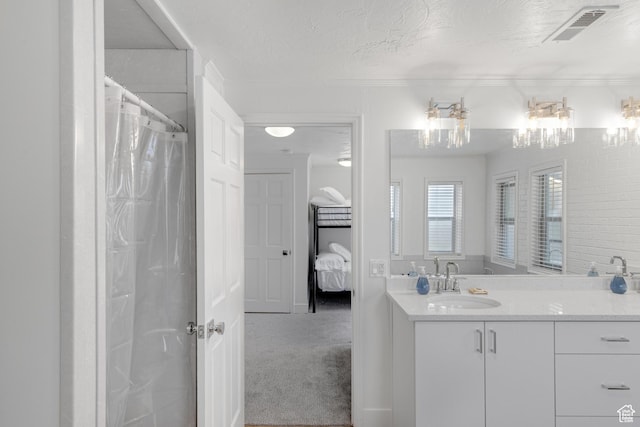 199 N 300 W, Garden City, UT 84028 - ensuite bathroom featuring a textured ceiling, visible vents, connected bathroom, curtained shower, and vanity