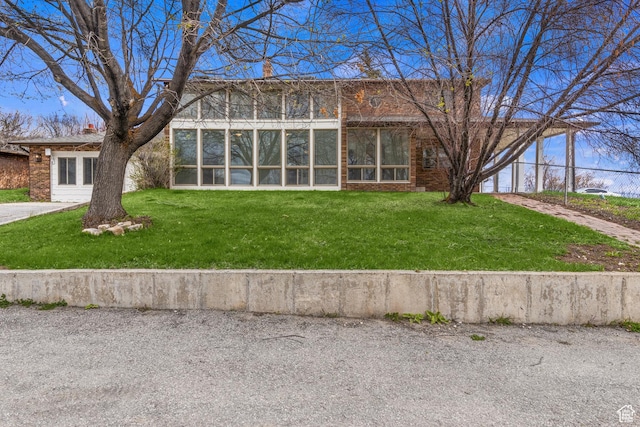 199 N 300 W, Garden City, UT 84028 - view of front of home with brick siding, a chimney, and a front lawn