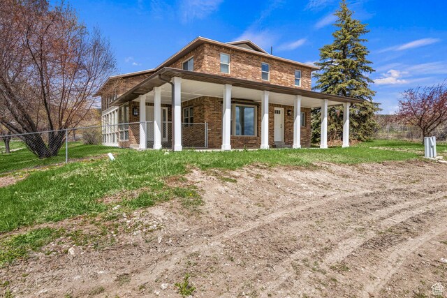 199 N 300 W, Garden City, UT 84028 - exterior space featuring a porch, fence, and brick siding
