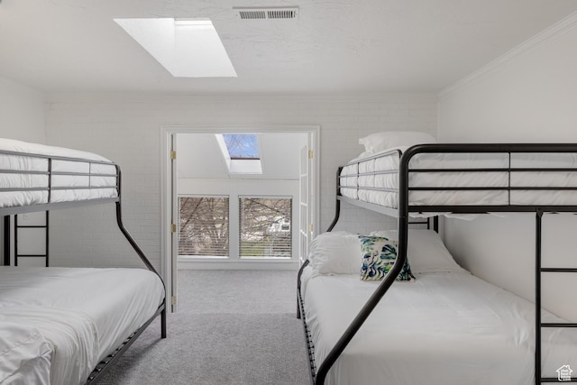 199 N 300 W, Garden City, UT 84028 - bedroom with visible vents, crown molding, a skylight, brick wall, and carpet floors