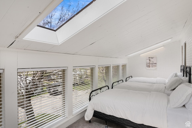 199 N 300 W, Garden City, UT 84028 - carpeted bedroom with lofted ceiling with skylight and brick wall