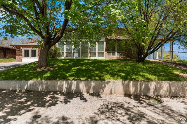 199 N 300 W, Garden City, UT 84028 - exterior space featuring brick siding and a front lawn