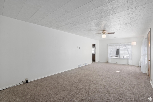 unfurnished living room featuring baseboards, visible vents, ceiling fan, and carpet flooring