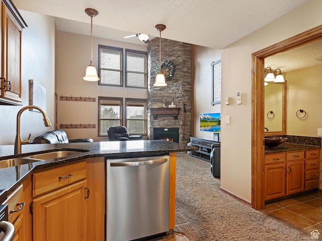 3615 N Wolf Lodge Dr E Unit 109, Eden, UT 84310 - kitchen with dishwasher, a sink, a stone fireplace, and dark carpet