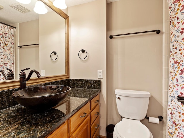 3615 N Wolf Lodge Dr E Unit 109, Eden, UT 84310 - full bathroom featuring toilet, vanity, a shower with shower curtain, and visible vents