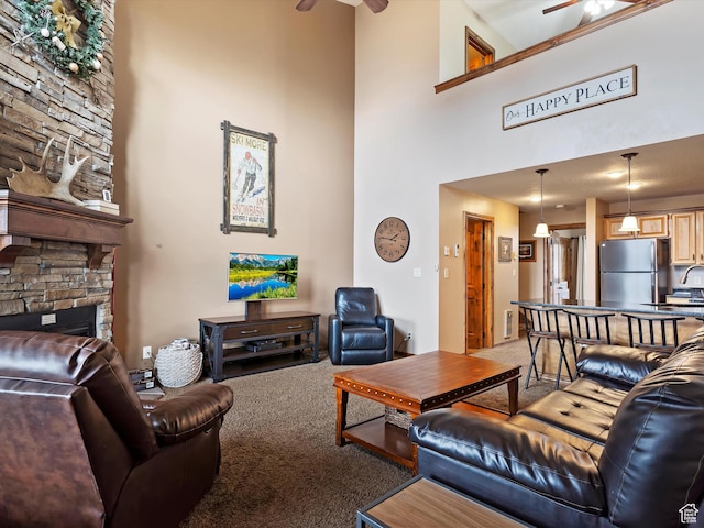 3615 N Wolf Lodge Dr E Unit 109, Eden, UT 84310 - living area with a high ceiling, a ceiling fan, a stone fireplace, and light colored carpet