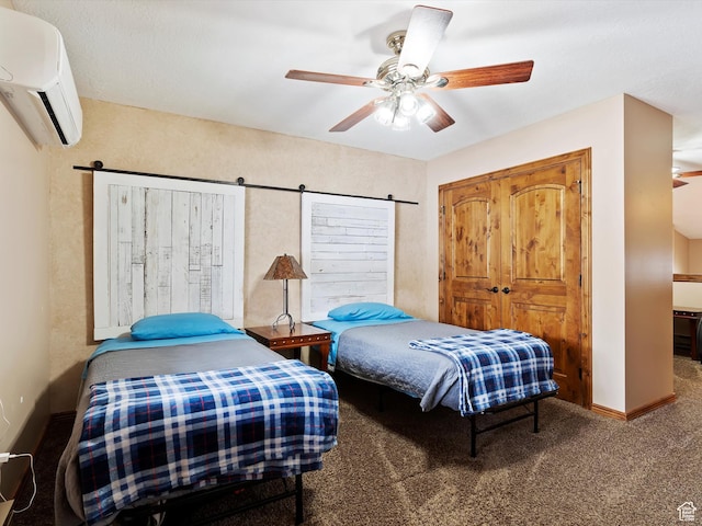 3615 N Wolf Lodge Dr E Unit 109, Eden, UT 84310 - carpeted bedroom with a barn door, baseboards, a wall mounted AC, and ceiling fan