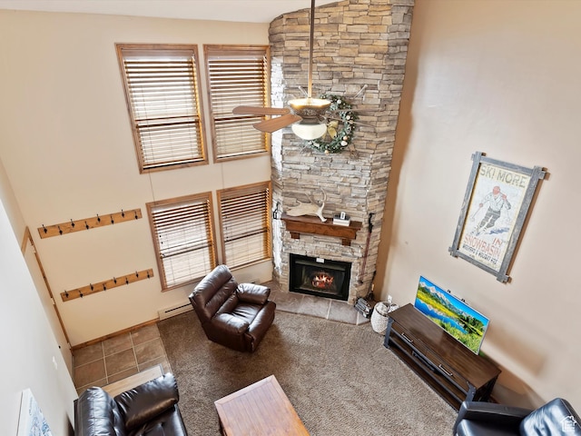 3615 N Wolf Lodge Dr E Unit 109, Eden, UT 84310 - living area with a baseboard radiator, a ceiling fan, tile patterned flooring, and a fireplace