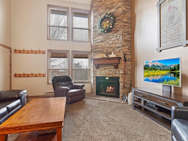 3615 N Wolf Lodge Dr E Unit 109, Eden, UT 84310 - living area featuring a wealth of natural light, a high ceiling, a baseboard heating unit, and a stone fireplace