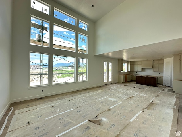 261 E 1150 N Unit 72, Salem, UT 84653 - unfurnished living room featuring a high ceiling and baseboards
