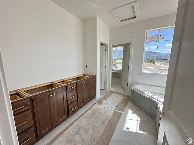 261 E 1150 N Unit 72, Salem, UT 84653 - bathroom featuring a bath and a textured ceiling