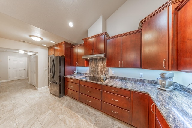 907 W 1840 S Unit B, Syracuse, UT 84075 - kitchen featuring vaulted ceiling, under cabinet range hood, dark stone counters, visible vents, and black appliances