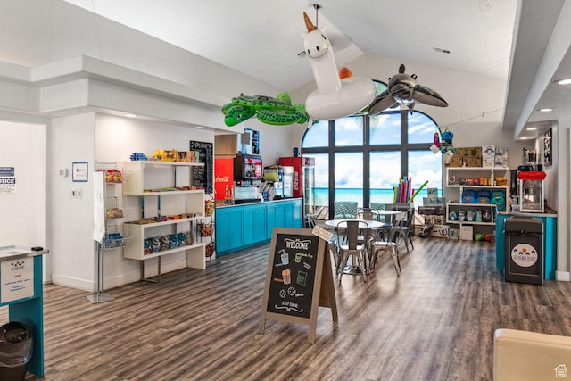 playroom featuring high vaulted ceiling, baseboards, wood finished floors, and visible vents