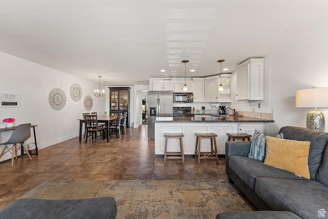 living room with an inviting chandelier, recessed lighting, stone finish flooring, and baseboards