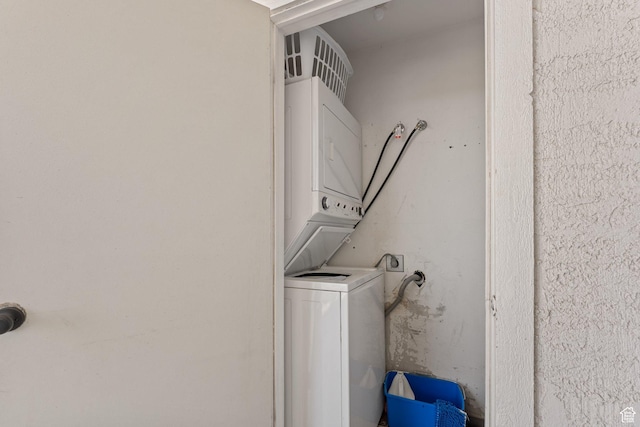 clothes washing area with laundry area and stacked washer / dryer