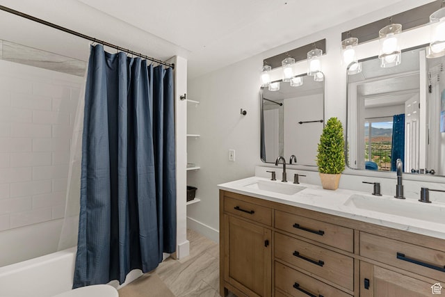 bathroom with double vanity, shower / bathtub combination with curtain, and a sink