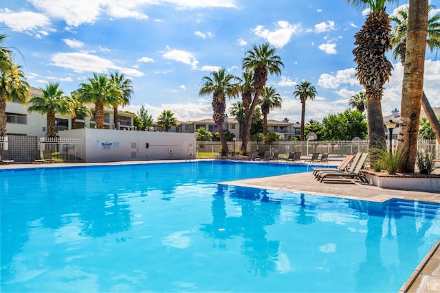 pool featuring fence and a residential view