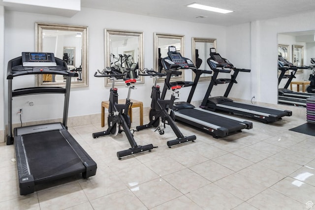exercise room featuring tile patterned floors