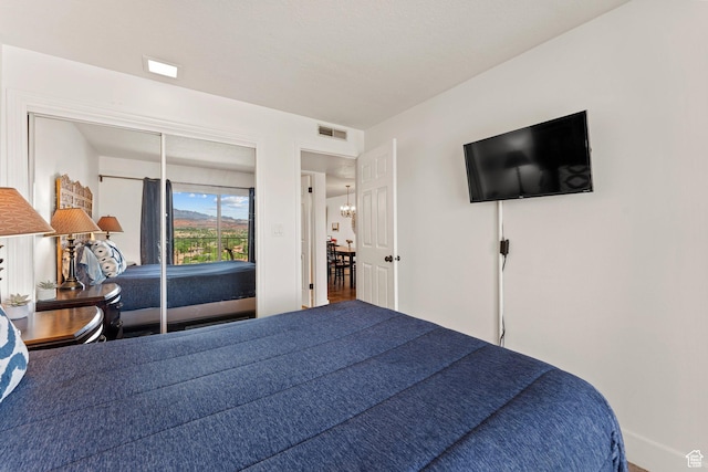 bedroom featuring baseboards and visible vents